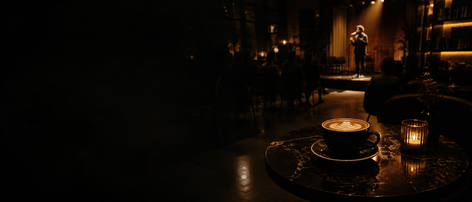 A performer on a stage in a dark venue.